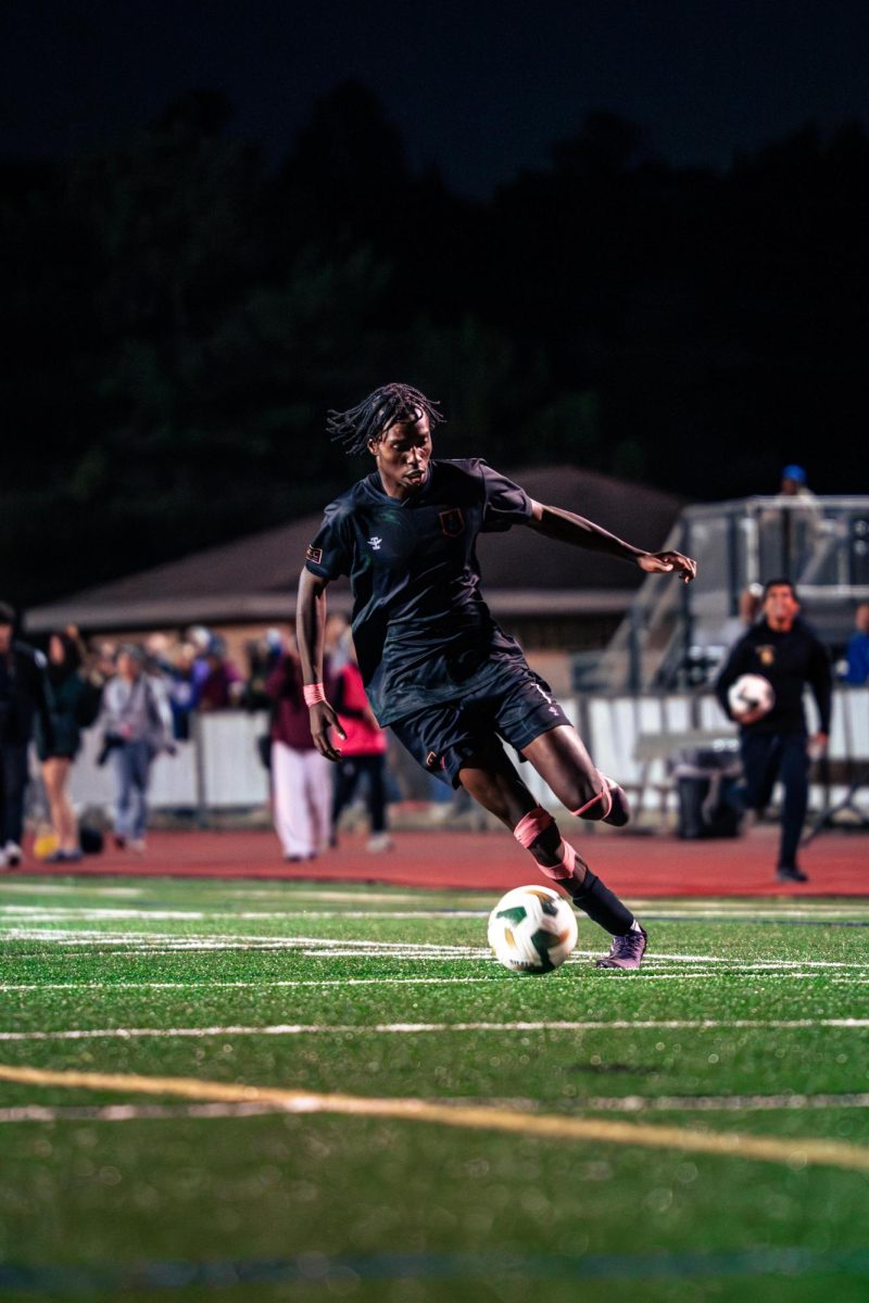 Senior Kinley Poole sprints with the ball towards the net. Poole scored the first goal of the game and crossed the ball that led to Huron's second goal. 