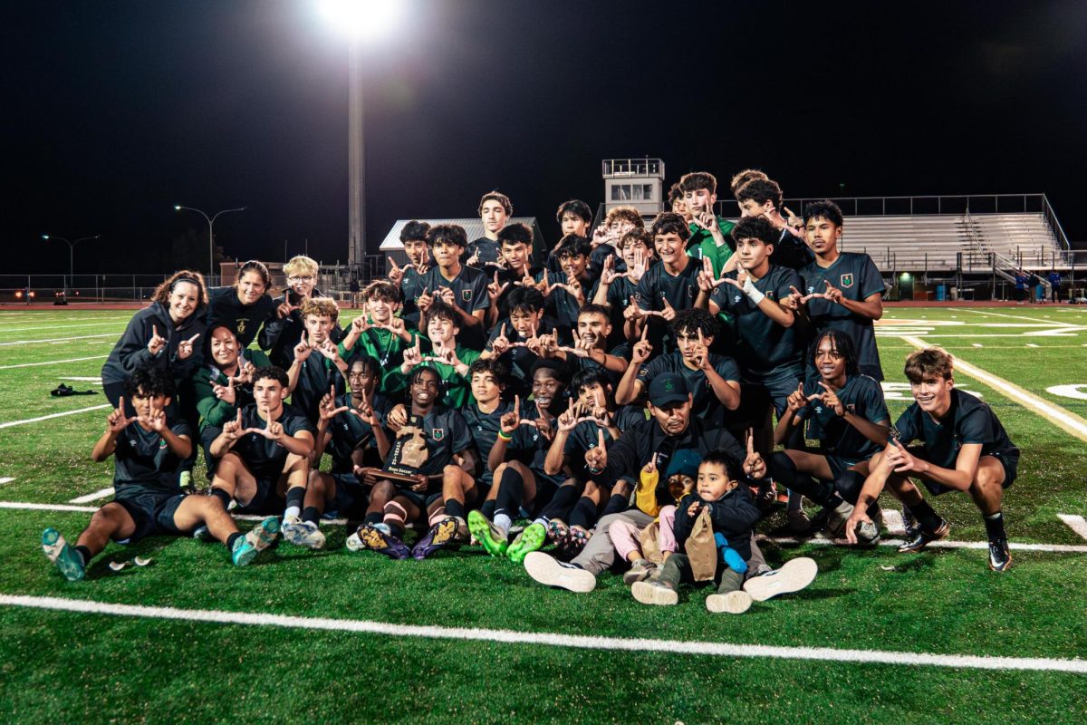 The River Rats make H's while posing for a team photo with the trophy. 