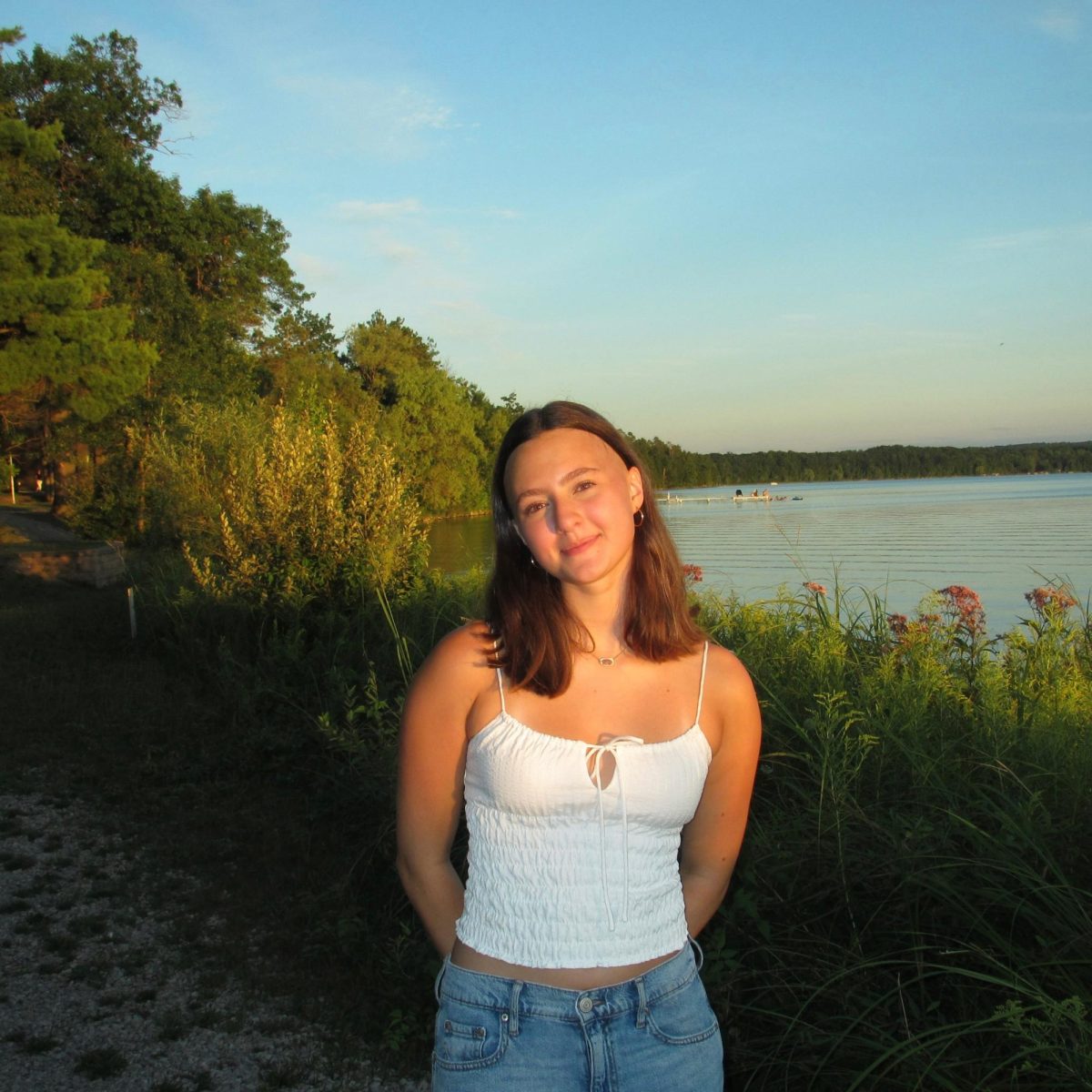 Pale posing for a photo in front of a lake. Courtesy of Pale. 