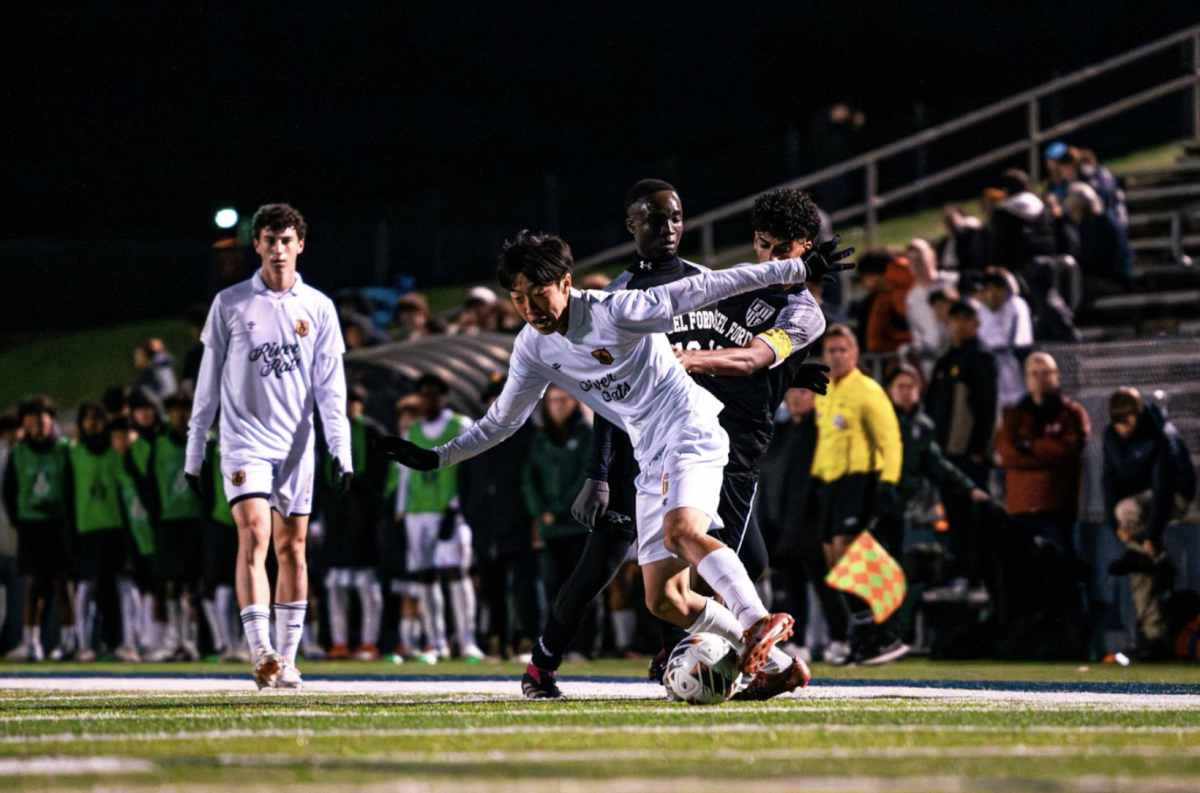 Youngest player on the team, sophomore Kaito Yoshida, dribbles around defenders while looking for an end result to his play.