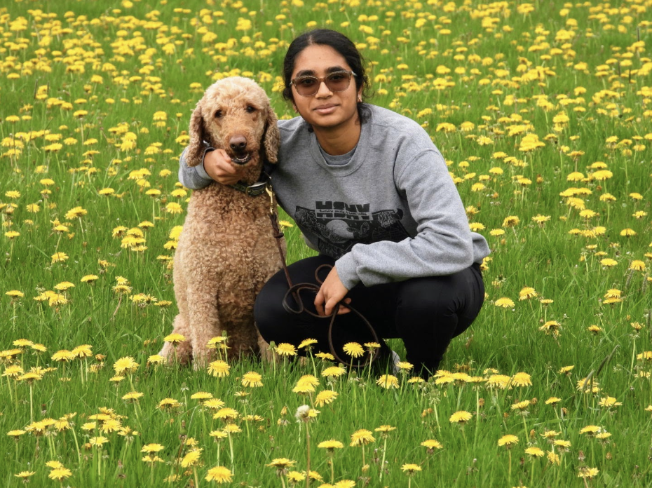 Pradeep posing for a photo with her dog. Courtesy of Pradeep.