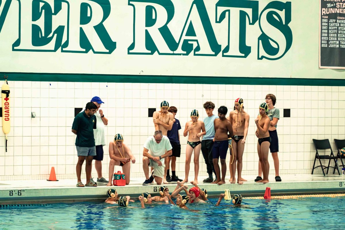 Players and coaches discuss game strategy between the first and second quarter in their game against Groves. 