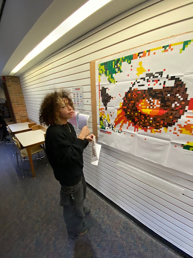 Milner doing the sticker puzzle at the Huron library. Courtesy of Milner. 