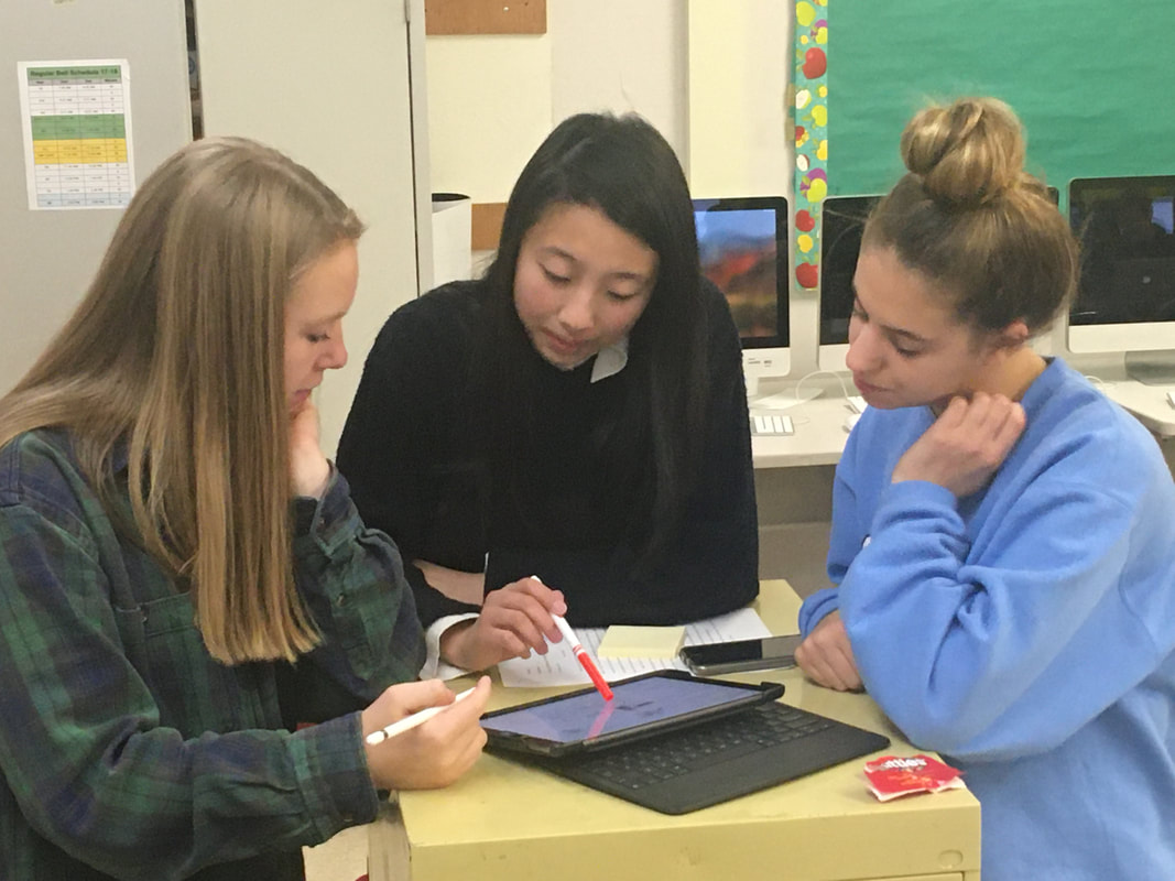 Heng designing the center spread with fellow student journalists