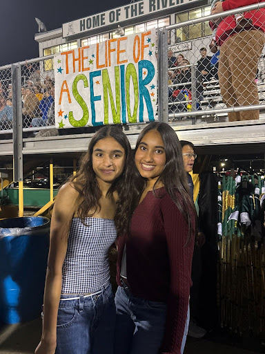 Tewari posing with a friend at a Huron game. Courtesy of Tewari. 