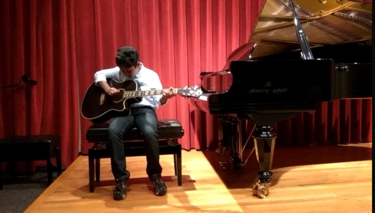 Abhi Velivela performing on the guitar at a middle school performance.

Picture courtesy of Hemanth Tavane Shivakumar. 