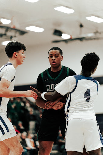 Holding his position, sophomore Johnny Epps sets up a strong screen in Huron’s battle against Pioneer High School, working to create scoring space for his teammate.