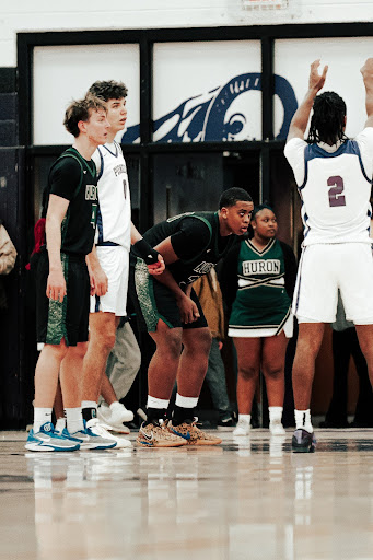 Sophomore Johnny Epps stands ready for the rebound as Pioneer High School shoots from the line in a competitive contest.
