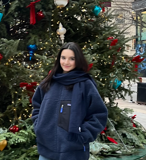 Senior Annaclare Regan in front of a Christmas tree during her trip. Courtesy of Annaclare Regan.
