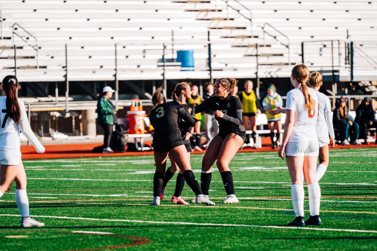 Celebrating freshman Ashley Tall first goal of the season senior Ayla Tindall and junior Mia Caruthers.