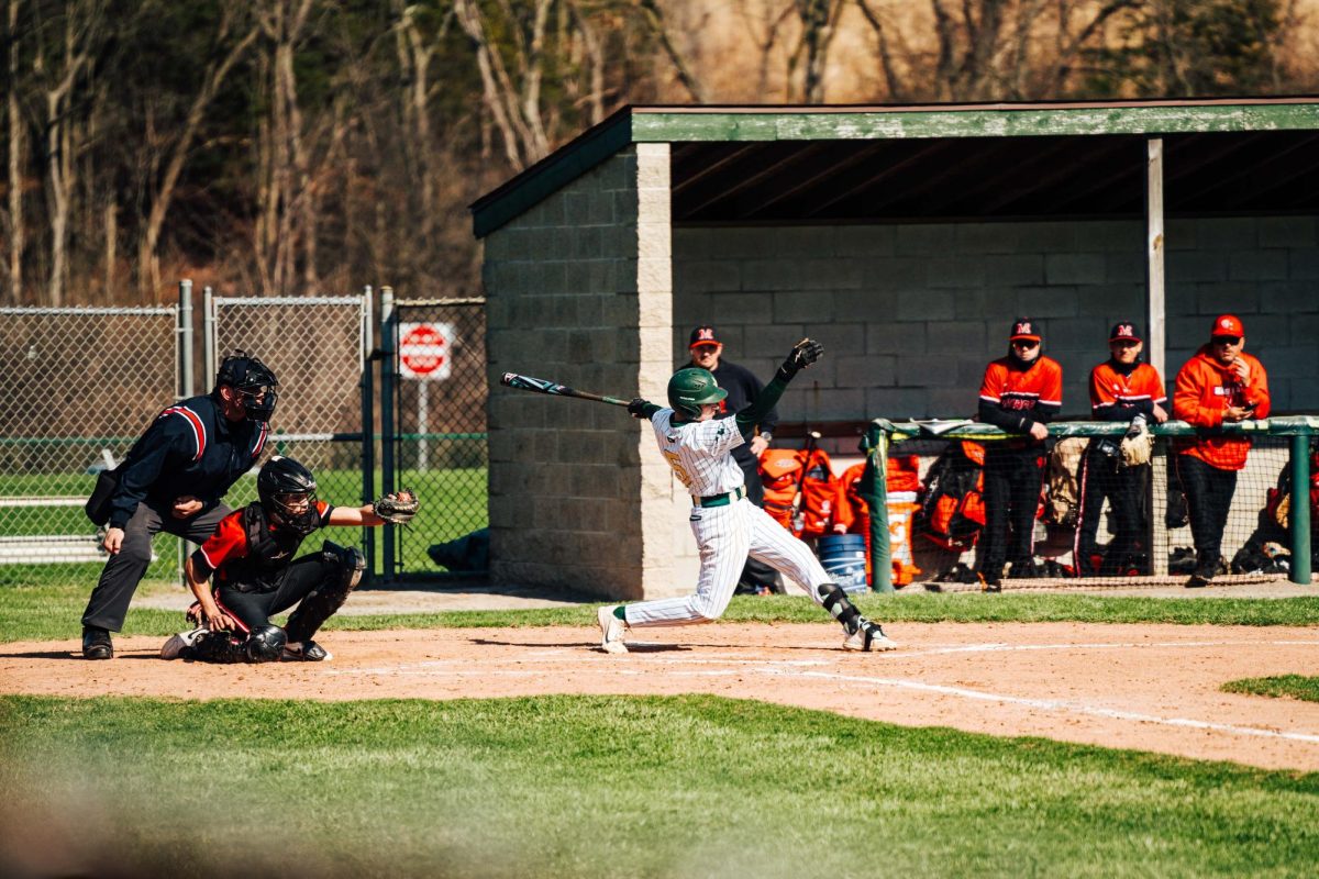 Junior Landon Wimmert takes a swing at the ball after a pitch from the Monroe pitcher. 
