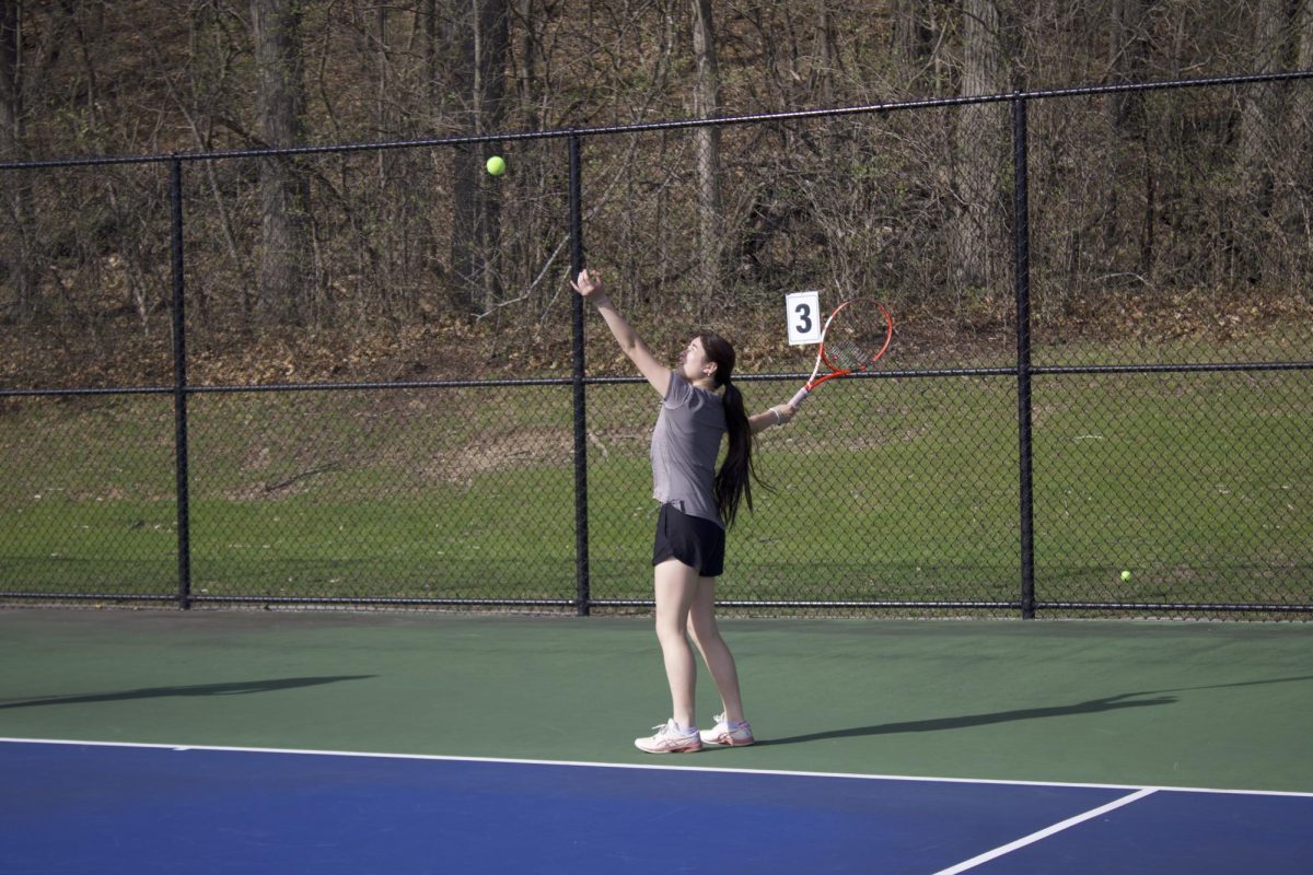 Junior Kayla Fu serves during practice.
