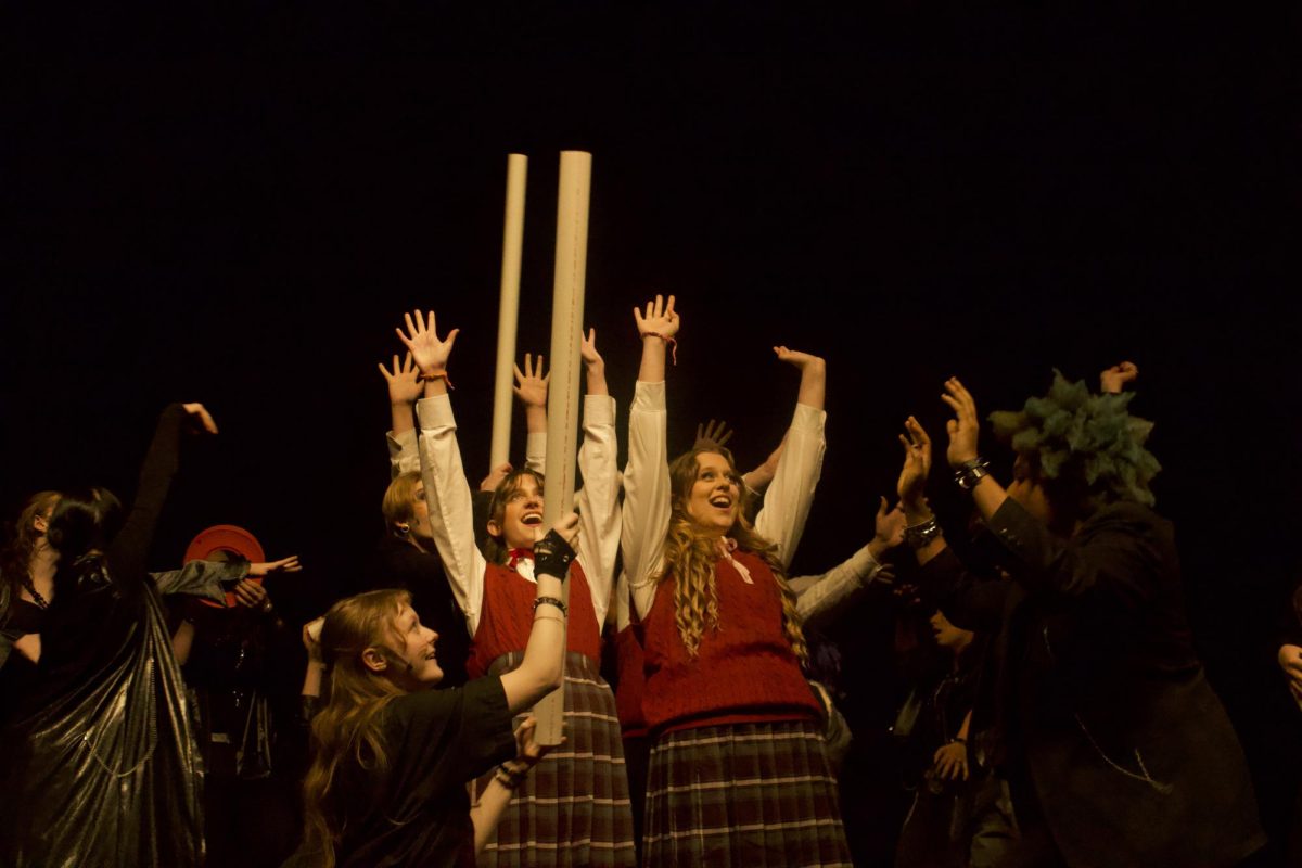 Hands raised in sync, Sasena and Nelson hit a high-energy moment during one of Sasena's more competitive numbers.