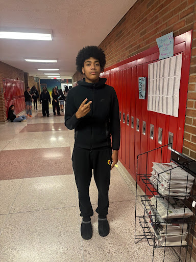 Busby posing for a photo in Huron's hallways. Courtesy of Busby. 