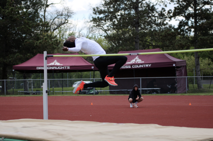 Senior Andrew Simpson-Vlach in the middle of his high jump event. 