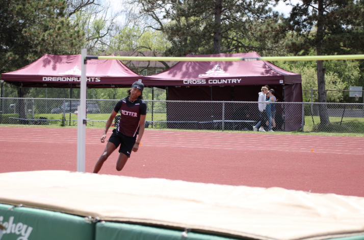 Junior Amarkus Royce performs a running start for his high jump event. 