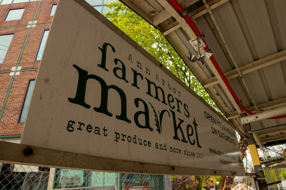 The Ann Arbor Farmers Market sign, saying “great produce and more since 1919," which shows the preservation of an over 107-year-long tradition. Courtesy of Jessica Milner and Ava Bryan