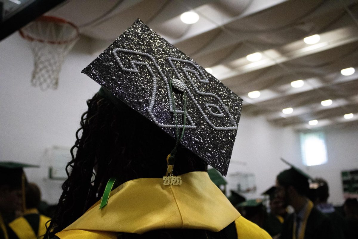 Waiting for the commencement to begin, senior Ashley Bradshaw talks with her friends.